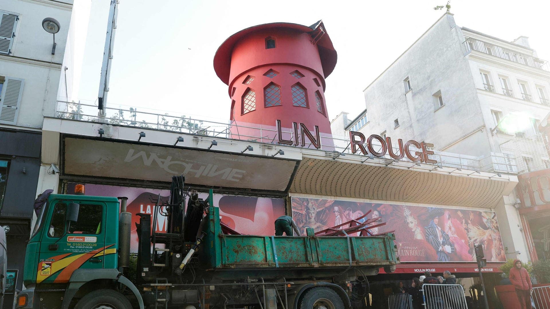 Arbeiter sichern den Bereich vor dem Kabarett, nachdem die Flügel des Windrads des Moulin Rouge abgestürzt sind. (Foto: dpa Bildfunk, picture alliance/dpa/AFP | Geoffroy Van Der Hasselt)
