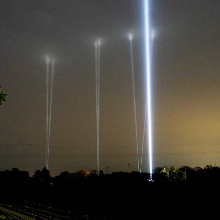 Mehrere Skybeamer leuchten in den Nachthimmel. Sie sollen Arian anlocken. (Foto: dpa Bildfunk, picture alliance/dpa | Jonas Walzberg)