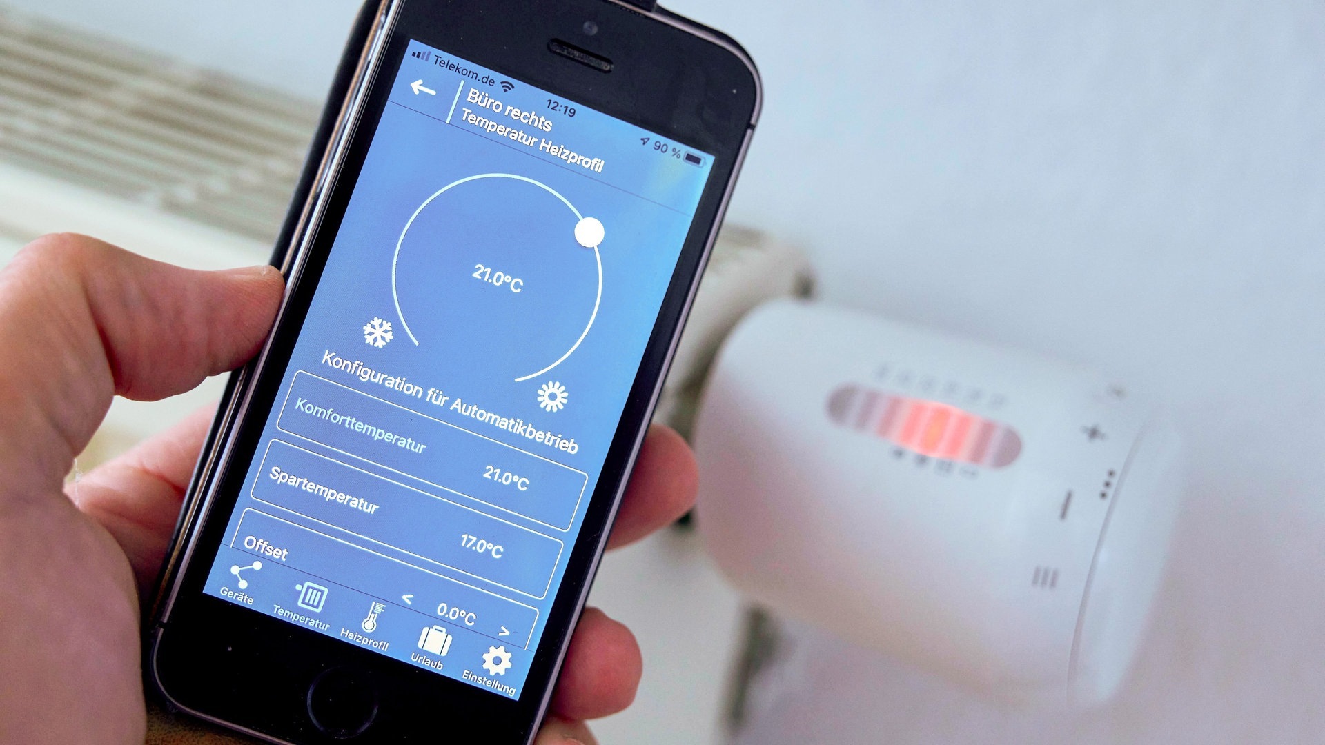 Elektronische Heizungsthermostat wird mit dem Handy eingestellt  (Foto: IMAGO, IMAGO / Kosecki)