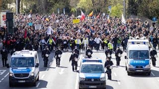 Ein Demonstrationszug der Bewegenung „Querdenken“ zieht durch Stuttgart. Polizisten sichern das Geschehen ab. (Foto: imago images, IMAGO / Nicolaj Zownir)