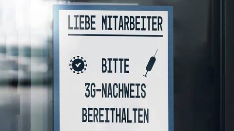 "Liebe Mitarbeiter, bitte 3G-Nachweis bereithalten", steht auf einem Schild. (Foto: IMAGO, imago images/Bihlmayerfotografie)