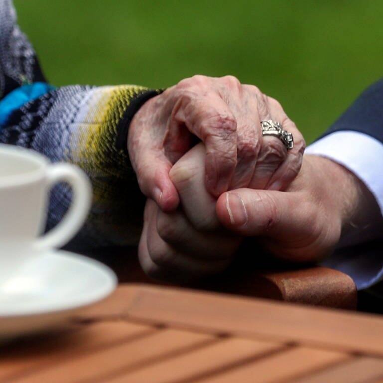 Eine Hand hält die Hand einer älteren Person fest (Foto: dpa Bildfunk, picture alliance/dpa/PA Wire | Simon Dawson)