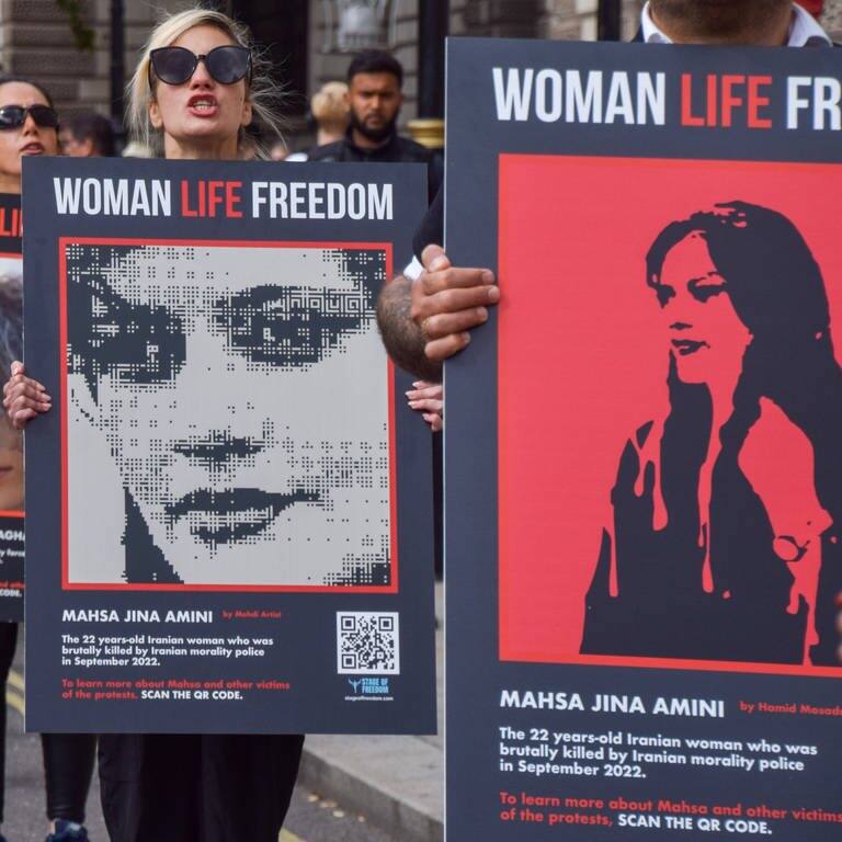 Nach dem Tod von Mahsa Amini im Iran:  Demonstrierende tragen Plakate auf denen steht „Woman, Life, Freedom“ (Foto: IMAGO, IMAGO/ZUMA Wire)