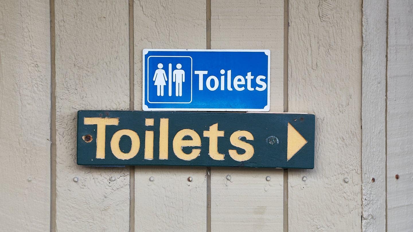 Ein Schild, das zu Toiletten weist (Foto: IMAGO, IMAGO / Pond5 Images)