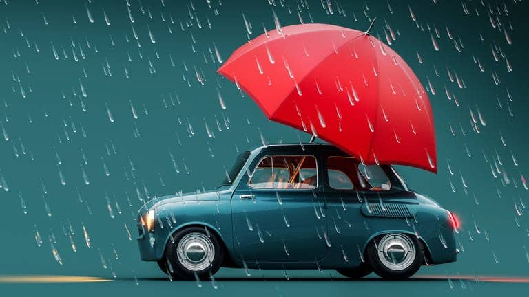 Ein Auto fährt mit Regenschirm am Fenster durch den Regen, ein Symbolbild für: Eine Frau aus Heidelberg hat an ihrem Auto ein Fenster offen gelassen, aber den plötzlichen Regen nicht eingeplant. Ein unbekannter Held half mit Regenschirm aus und steckte ihn in das Autofenster. 
