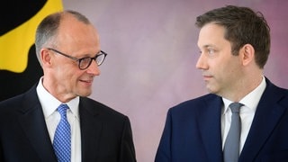 Friedrich Merz und Lars Klingbeil schauen sich an.