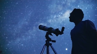 Astronom mit einem Teleskop.