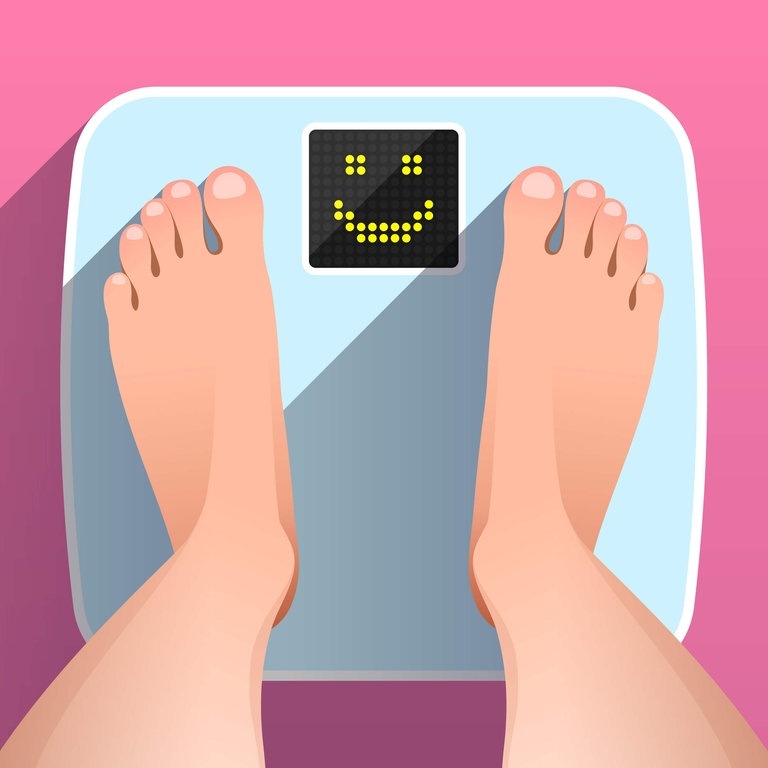 Füße auf einer Waage mit Smiley (Foto: Adobe Stock / Elena Abrazhevich )