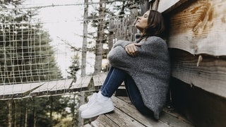 Warum der November ein toller Monat ist – Grund 1: Entschleunigung. Symbolbild von einer jungen Frau, die im Wald angelehnt an eine Holzhütte sitzt. (Foto: IMAGO, IMAGO / Westend61) Warum der November ein toller Monat ist – Grund 1: Entschleunigung. Symbolbild von einer jungen Frau, die im Wald angelehnt an eine Holzhütte sitzt.