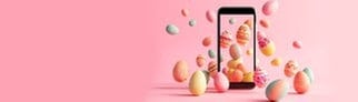 Smartphone mit Ostereiern. Symbolbild für Lustige Whatsapp-Sprüche und Grüße zu Ostern.