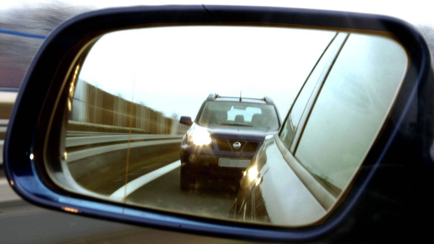 dicht auffahrendes Auto im Außenspiegel, ein so genannter Drängler mit eingeschalteten Scheinwerfern (Foto: dpa - Bildfunk)