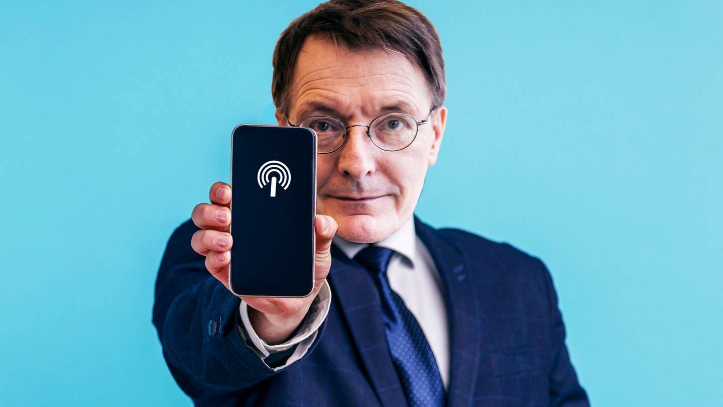 Lauterbach zeigt Handy mit Hotspot (Foto: picture-alliance / Reportdienste, picture-alliance)