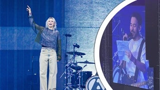 Emily Armstrong und Mike Shinoda von Linkin Park performen bei ihrem Konzert in Hannover auf der Bühne und sprechen Deutsch.