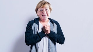 Merkel macht entschuldigende Geste