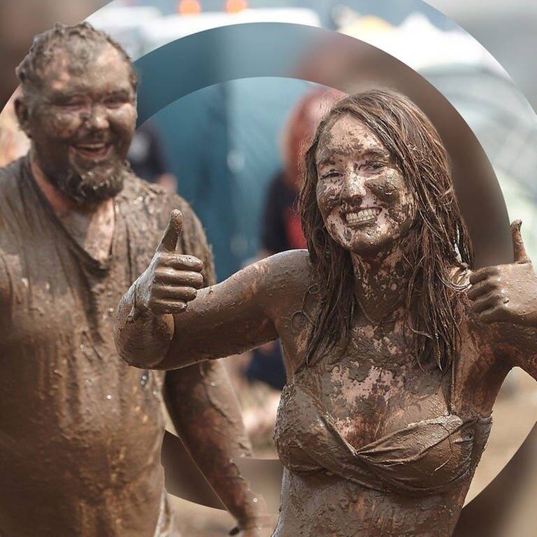 Eine Frau und ein Mann sind schlammverschmiert auf dem Festivalgelände von Rock am Ring. (Foto: dpa Bildfunk, Picture Alliance)