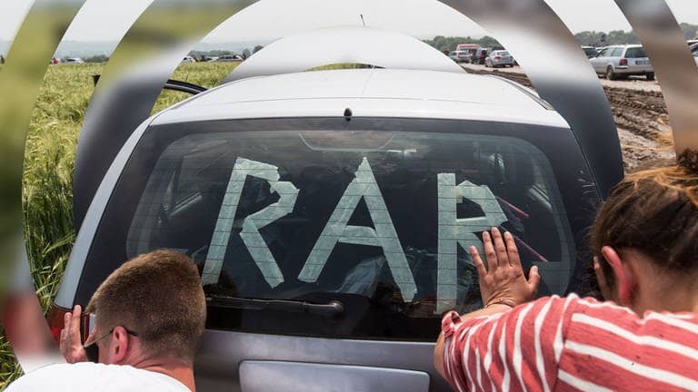 Rock am Ring: Zwei Menschen schieben ein Auto mit dem Schriftzug „RaR“. (Foto: picture-alliance / Reportdienste, picture alliance / POP-EYE | POP-EYE / Ben Kriemann|Bearbeitung: SWR3)