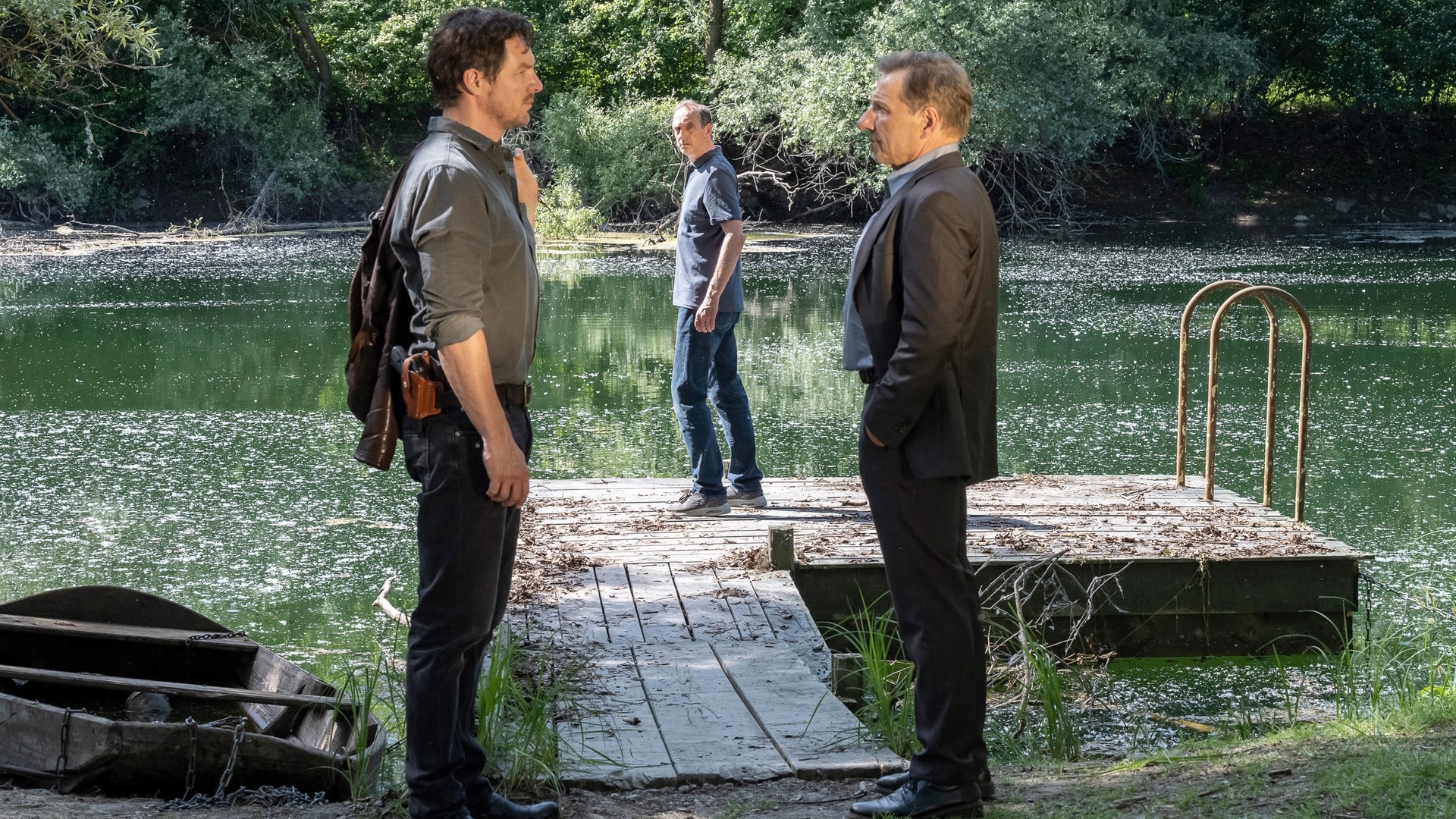 Foto: ard-foto s2-intern/extern, SWR / Patricia Neligan Tatort „Vergebung“ Stuttgart: Lannert und Bootz stehen sich am Neckarufer gegenüber. Vorne an einem Steg steht Gerichtsmediziner Vogt. (Foto: ard-foto s2-intern/extern, SWR / Patricia Neligan)