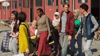 Hauptkommissar Felix Voss (Fabian Hinrichs, 2. von rechts) trifft auf den jungen syrischen Flüchtling Basem Hemidi (Mohammed Issa, rechts). (Foto: BR/Rat Pack Filmproduktion GmbH/Bernd Schuller) Hauptkommissar Felix Voss (Fabian Hinrichs, 2. von rechts) trifft auf den jungen syrischen Flüchtling Basem Hemidi (Mohammed Issa, rechts).